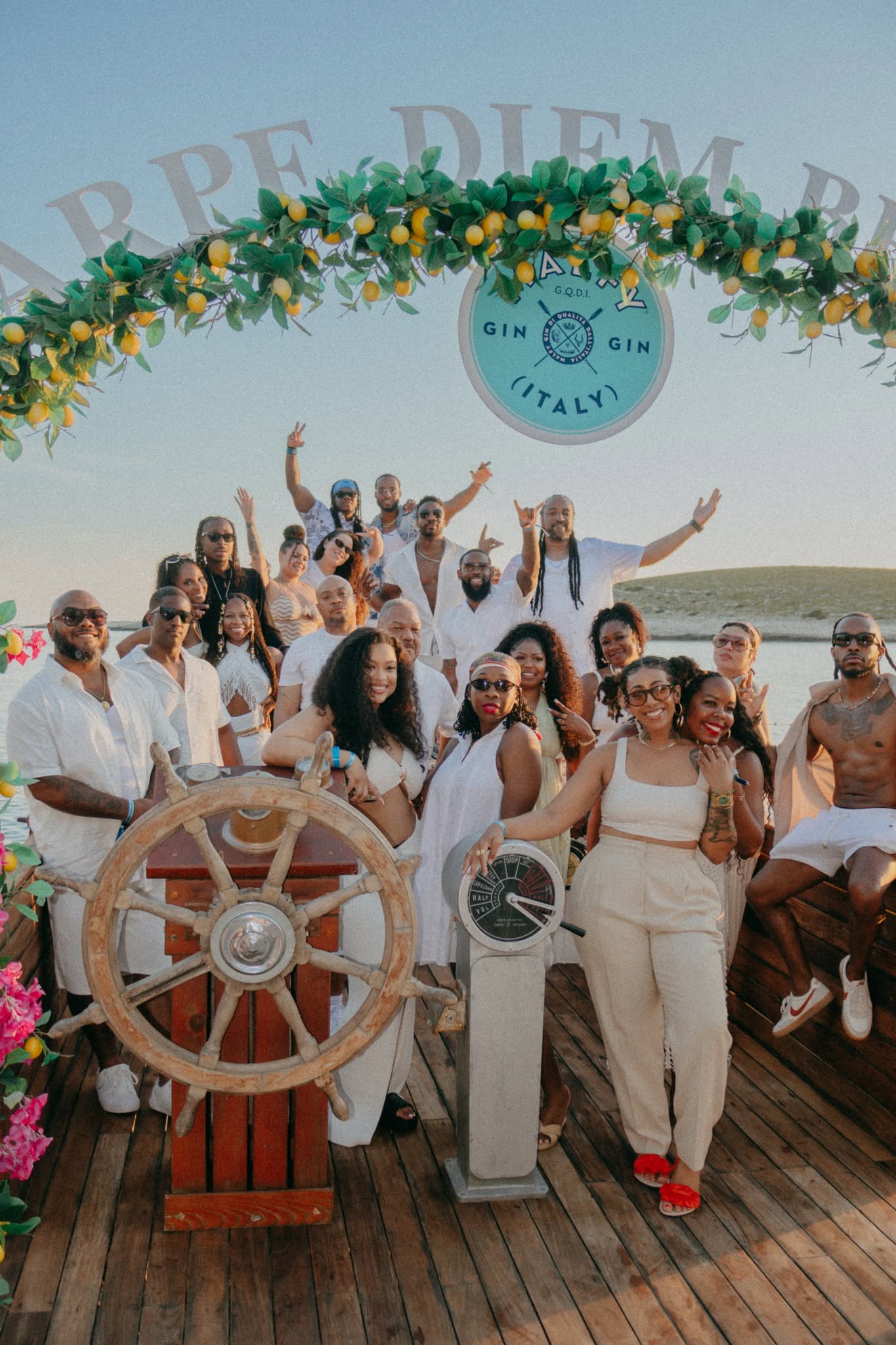The Yacht Week group gathered at the ship's wheel under a lemon garland in Croatia