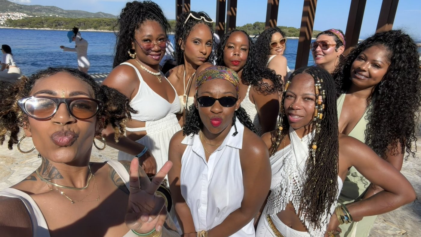 The Yacht Week group dressed in white at a lakeside pergola in Croatia