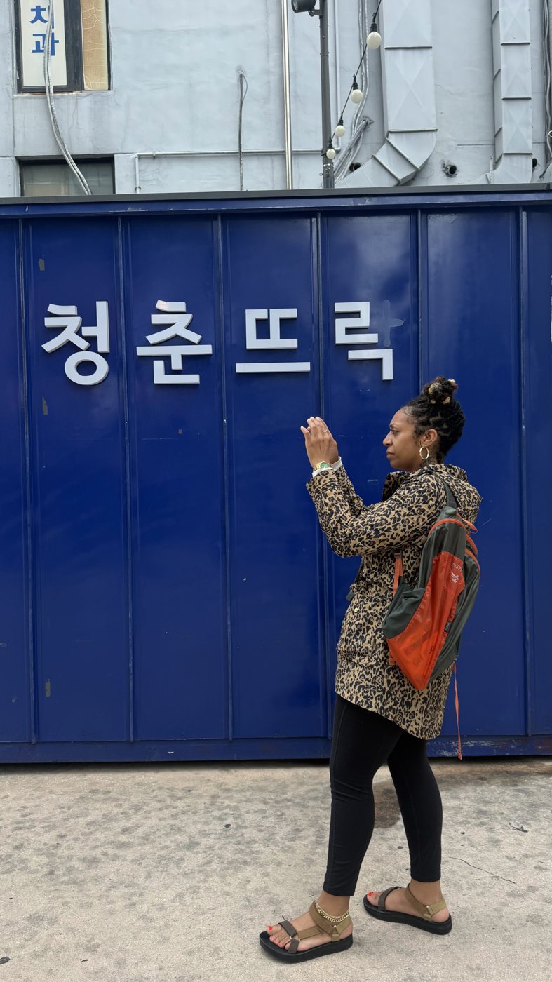 Ashleigh Bing in front of a blue shipping container in Korea