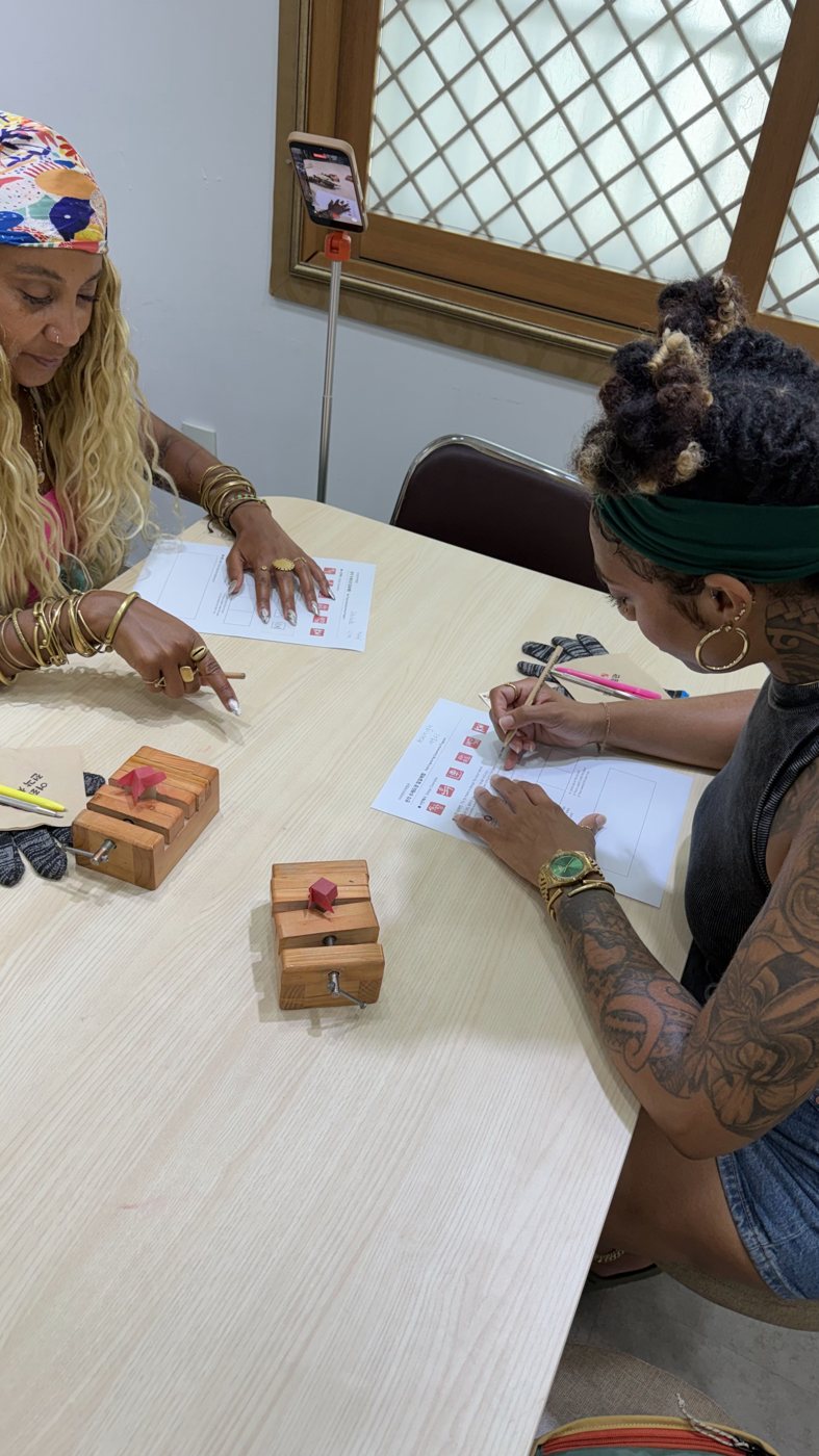 Ashleigh Bing and a friend at a craft table in Korea
