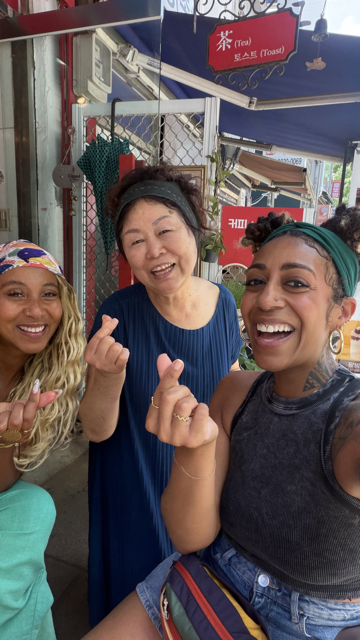 Ashleigh Bing sharing a finger heart with a local shop owner in Korea