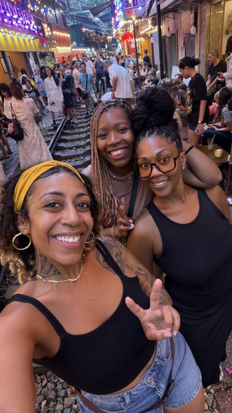 Ashleigh Bing with two friends at a night market