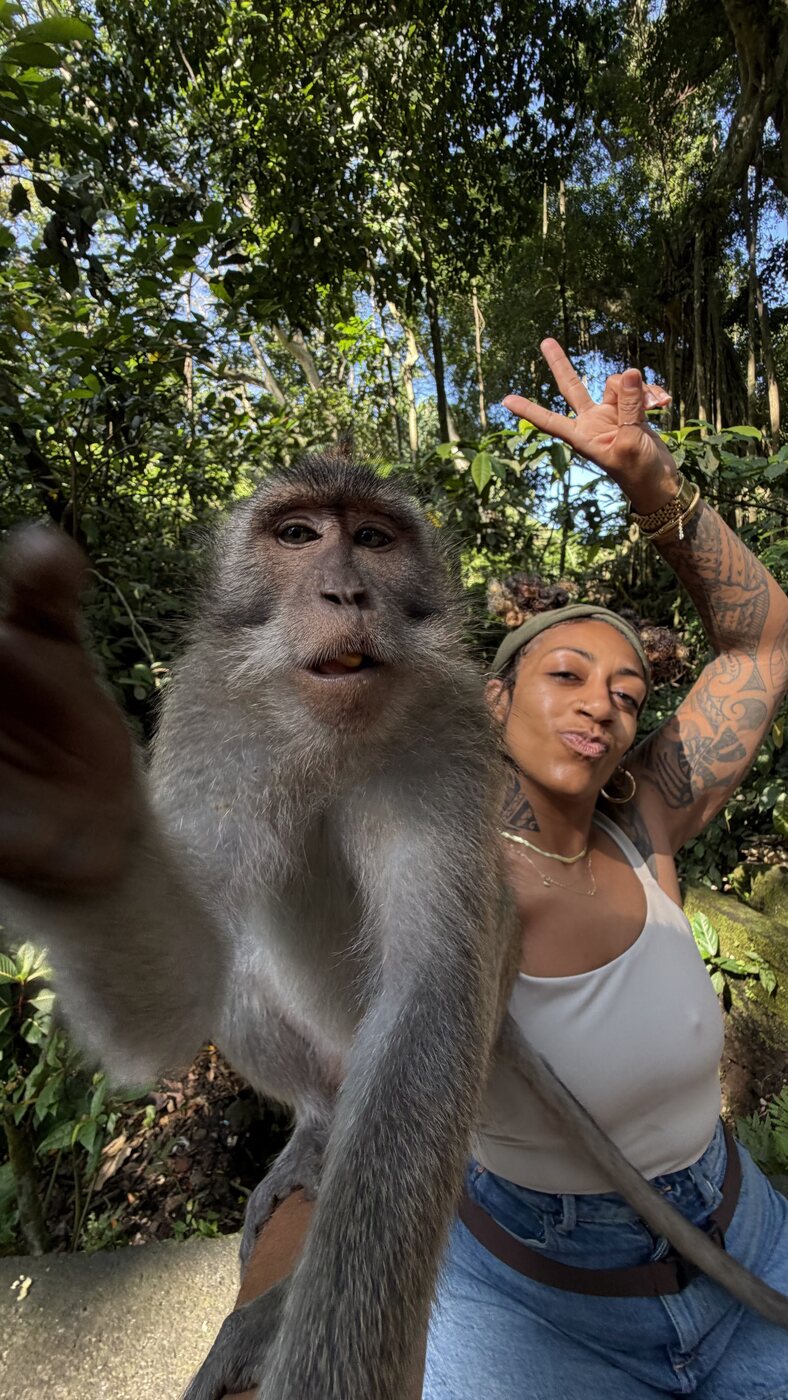Ashleigh Bing taking a selfie with a monkey in Bali